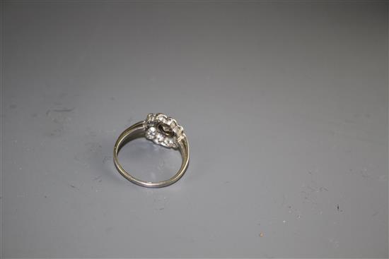 A white metal and eleven stone diamond circular cluster ring, size K, gross weight 3.1 grams.